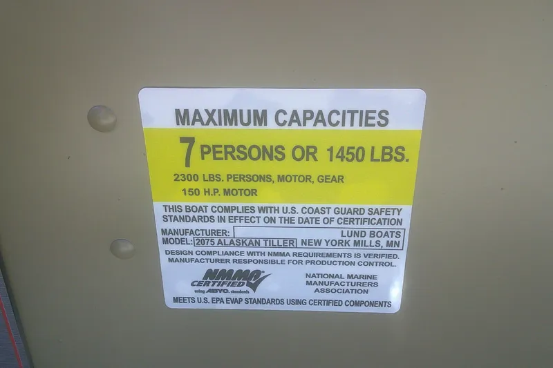 Slide: The Image of 2026 Lund 2075 Alaskan Tiller capacity label: 7 persons, 1450 lbs, 150 HP motor. - 7