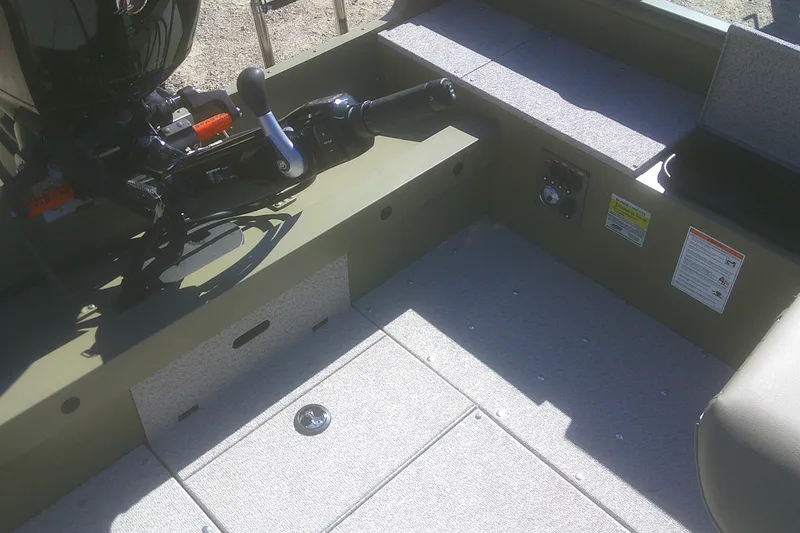 Slide: The Image of 2026 Lund 2075 Alaskan Tiller boat interior with motor and control panel. - 8