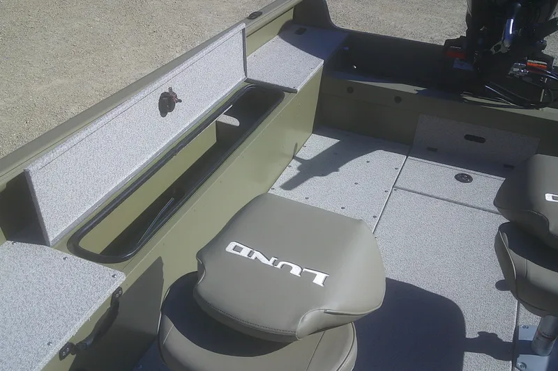 Slide: The Image of 2026 Lund 2075 Alaskan Tiller boat interior with seating and storage compartments. - 9