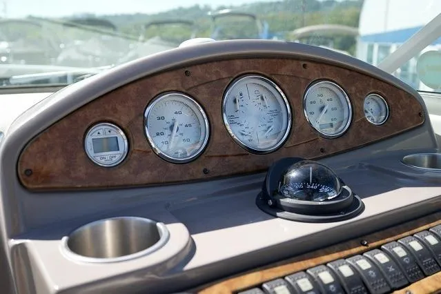 Slide: The Image of Dashboard of 2007 Rinker 280 Fiesta Vee boat with gauges and compass. - 10