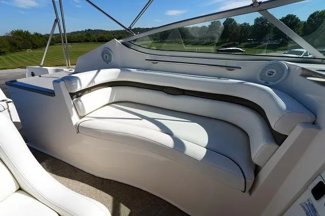 Slide: The Image of 2007 Rinker 280 Fiesta Vee boat interior with white seating and outdoor view. - 11