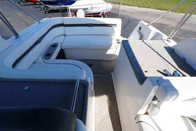Slide: The Image of 2007 Rinker 280 Fiesta Vee boat interior with white seating and deck area. - 12