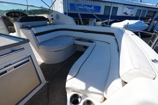 Slide: The Image of 2007 Rinker 280 Fiesta Vee boat interior with white seating and cup holders. - 14