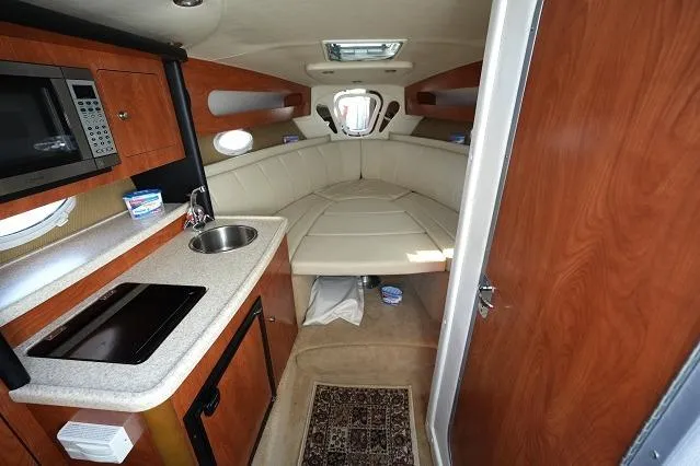 Slide: The Image of 2007 Rinker 280 Fiesta Vee cabin interior with kitchenette and seating area. - 16