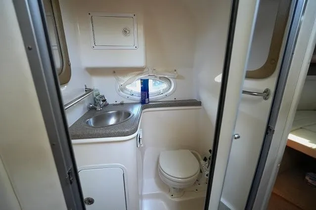 Slide: The Image of 2007 Rinker 280 Fiesta Vee boat bathroom with sink and toilet. - 19