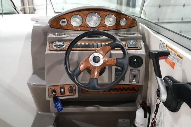Slide: The Image of 2007 Rinker Fiesta Vee 280 helm with wood accents and modern controls. - 21