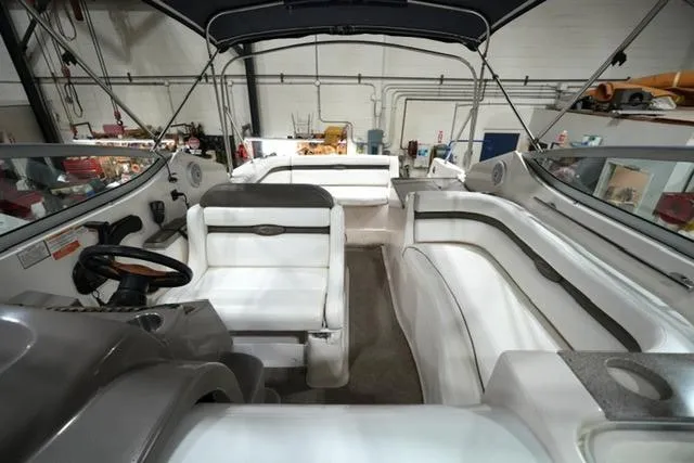 Slide: The Image of 2007 Rinker Fiesta Vee 280 boat interior with white seating and steering wheel. - 23