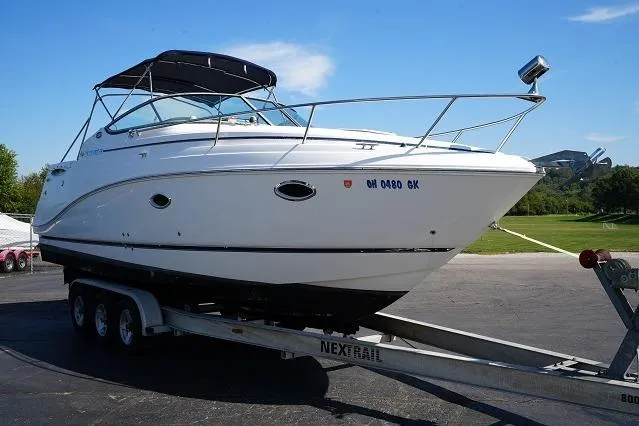 Slide: The Image of 2007 Rinker 280 Fiesta Vee boat on trailer, parked outdoors under clear blue sky. - 3