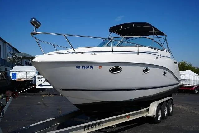 Slide: The Image of 2007 Rinker 280 Fiesta Vee boat on trailer, displayed outdoors under clear blue sky. - 4