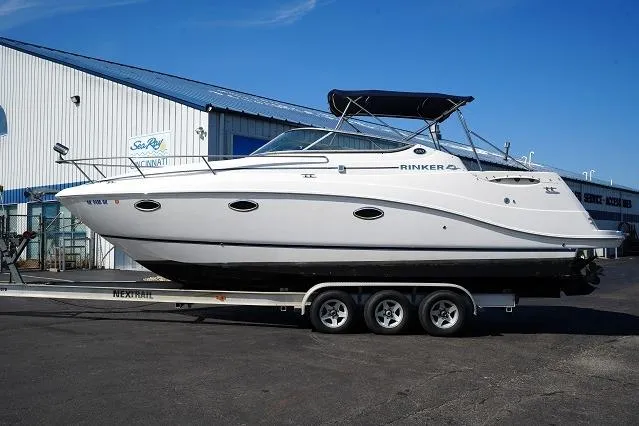 Slide: The Image of 2007 Rinker 280 Fiesta Vee boat on trailer, parked outside a marine service center. - 7