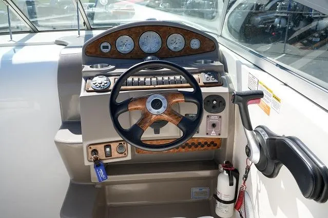 Slide: The Image of 2007 Rinker 280 Fiesta Vee boat dashboard with steering wheel and control panel. - 9