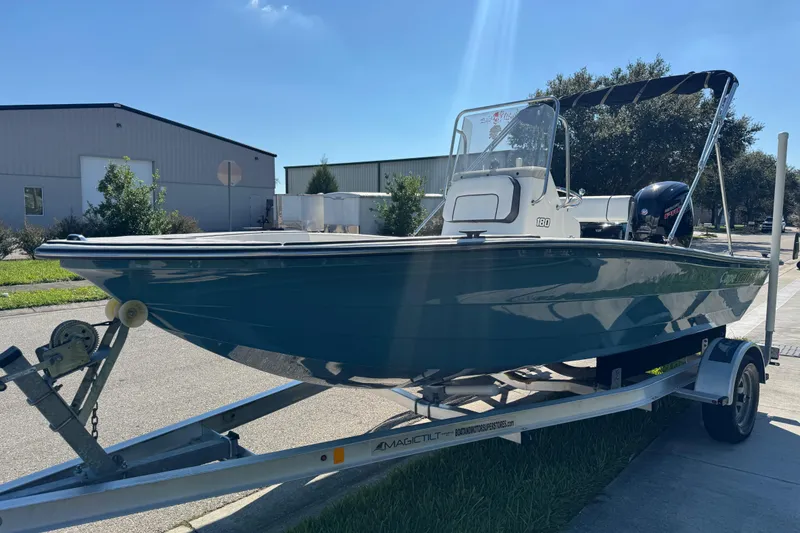 Slide: The Image of 2019 Cape Craft 180 boat on trailer, parked outdoors under clear sky. - 11