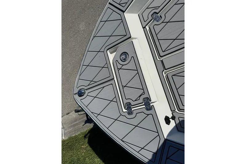 Slide: The Image of 2019 Cape Craft 180 boat deck with gray non-slip surface and storage compartments. - 16