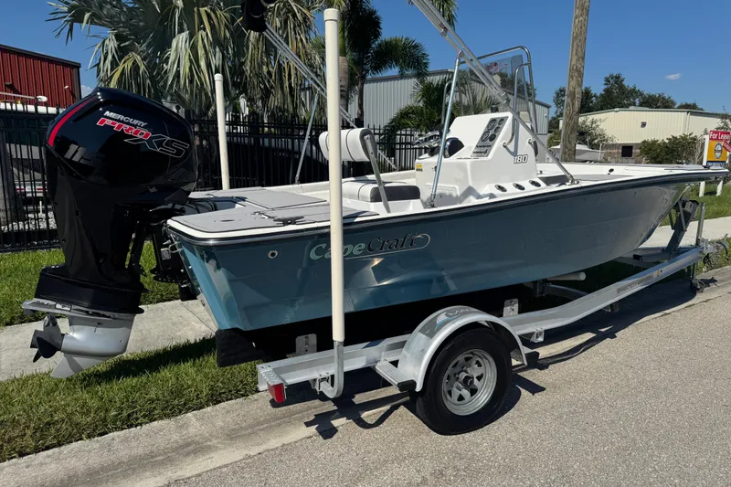 Slide: The Image of 2019 Cape Craft 180 boat with Mercury Pro XS engine on a trailer, parked outdoors. - 2