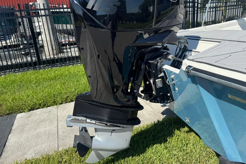 Slide: The Image of 2019 Cape Craft 180 boat with outboard motor, parked on grass. - 7