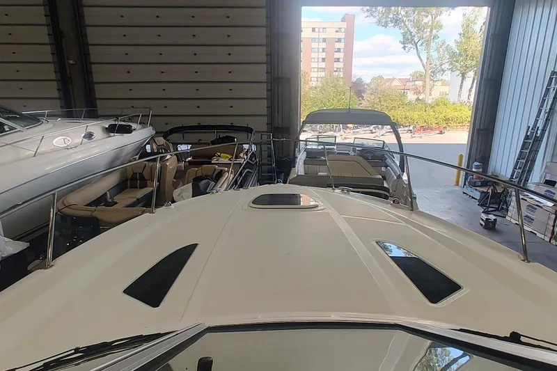Slide: The Image of 2011 Sea Ray 330 Sundancer in storage, surrounded by other boats. - 12