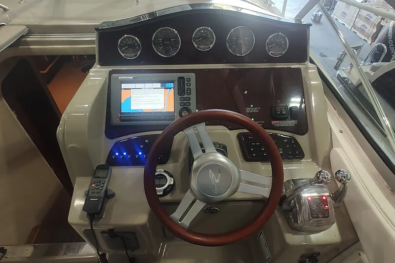 Slide: The Image of 2011 Sea Ray 330 Sundancer helm with GPS, gauges, and controls. - 13