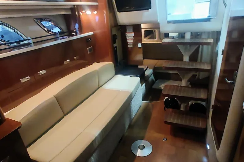 Slide: The Image of Interior of 2011 Sea Ray 330 Sundancer yacht with beige seating and wooden accents. - 17