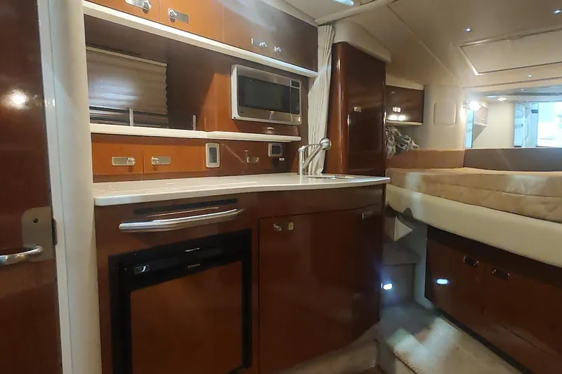 Slide: The Image of Interior of 2011 Sea Ray 330 Sundancer yacht with kitchenette and sleeping area. - 20