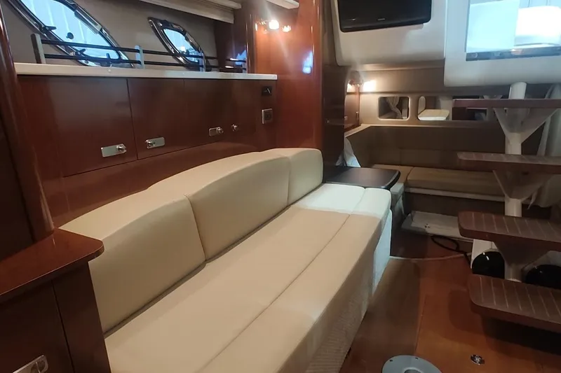 Slide: The Image of Luxurious interior of 2011 Sea Ray 330 Sundancer yacht with elegant seating and wooden finishes. - 21