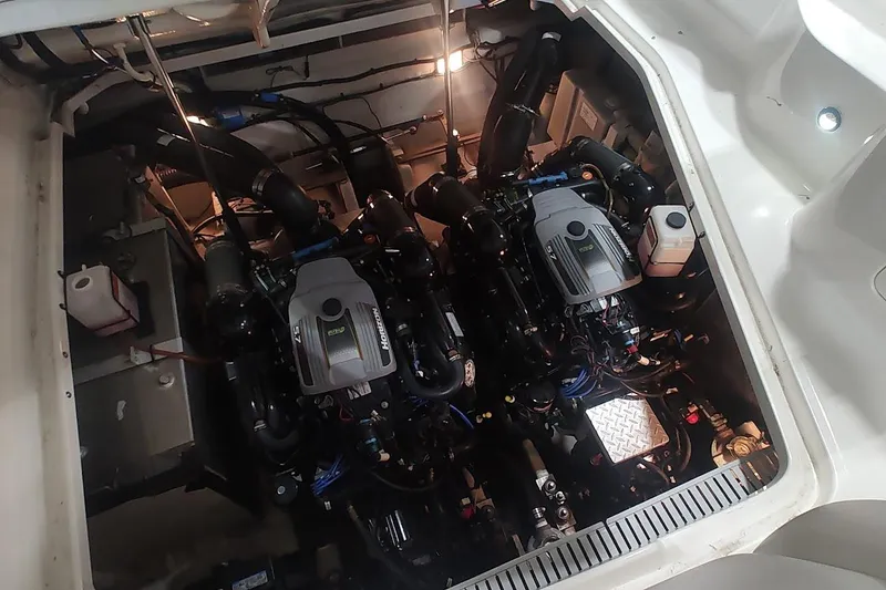 Slide: The Image of Engine compartment of 2011 Sea Ray 330 Sundancer with twin motors and mechanical components. - 24