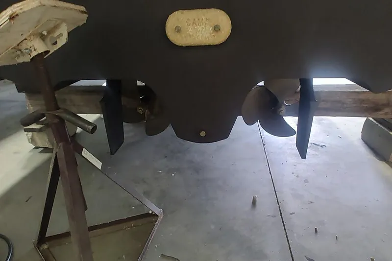 Slide: The Image of 2011 Sea Ray 330 Sundancer propellers and rudders in a workshop setting. - 27