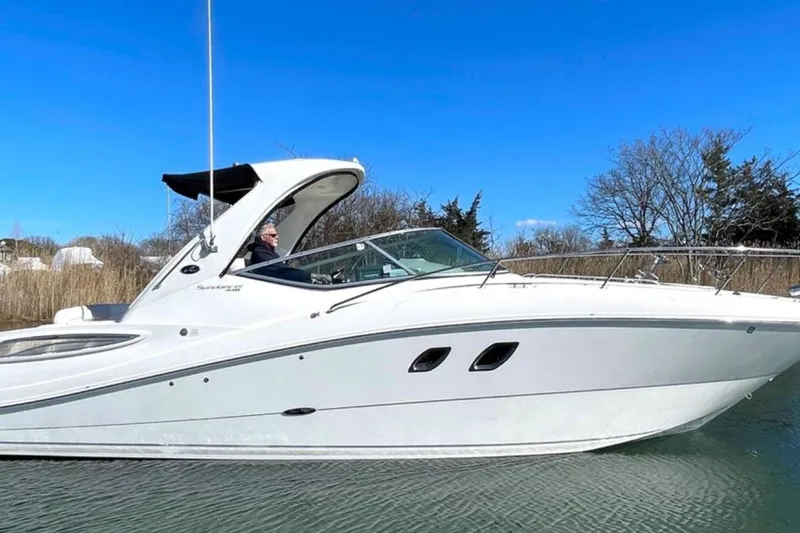 Slide: The Image of 2011 Sea Ray 330 Sundancer boat cruising on a clear day. - 3