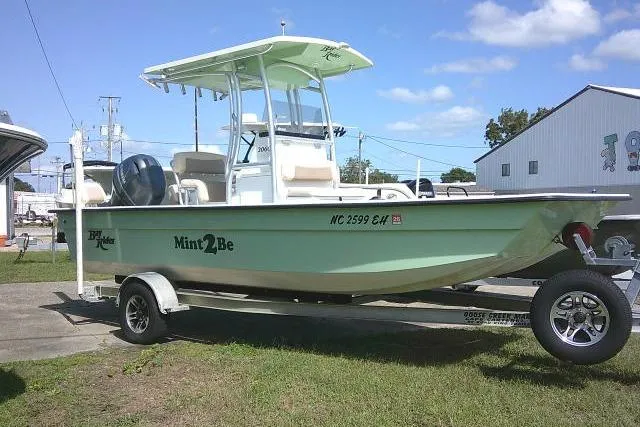 The Image of 2018 KenCraft 2060 BAYRIDER boat in mint green on a trailer, parked outdoors. - 0