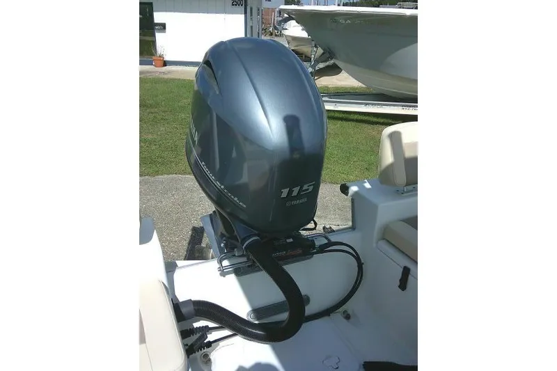Slide: The Image of 2018 KenCraft 2060 BAYRIDER with Yamaha 115 outboard motor, parked outdoors. - 21