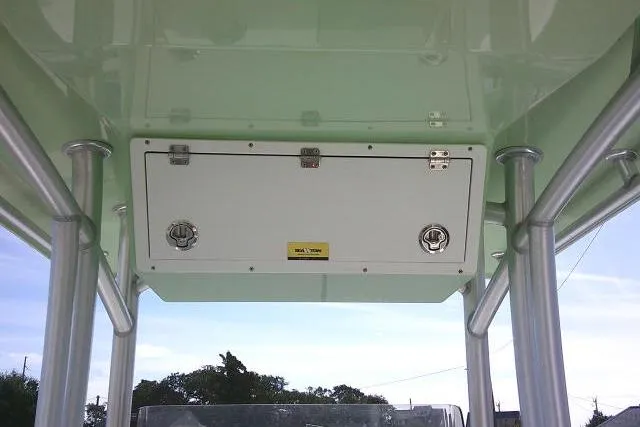 Slide: The Image of 2018 KenCraft 2060 BAYRIDER boat storage compartment with metal supports and clear sky background. - 28