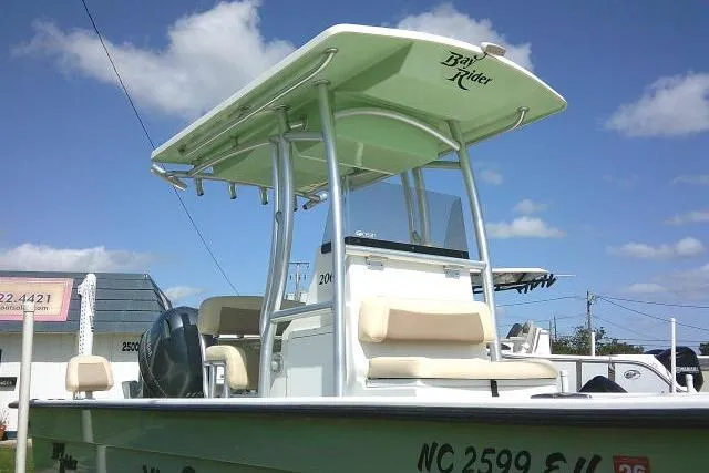 Slide: The Image of 2018 KenCraft 2060 BAYRIDER boat with T-top, parked outdoors under blue sky. - 4