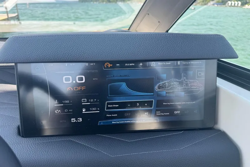 Slide: The Image of 2025 Nautique Super Air Nautique G23 dashboard display with speed, wake shape, and steering assist controls. - 6