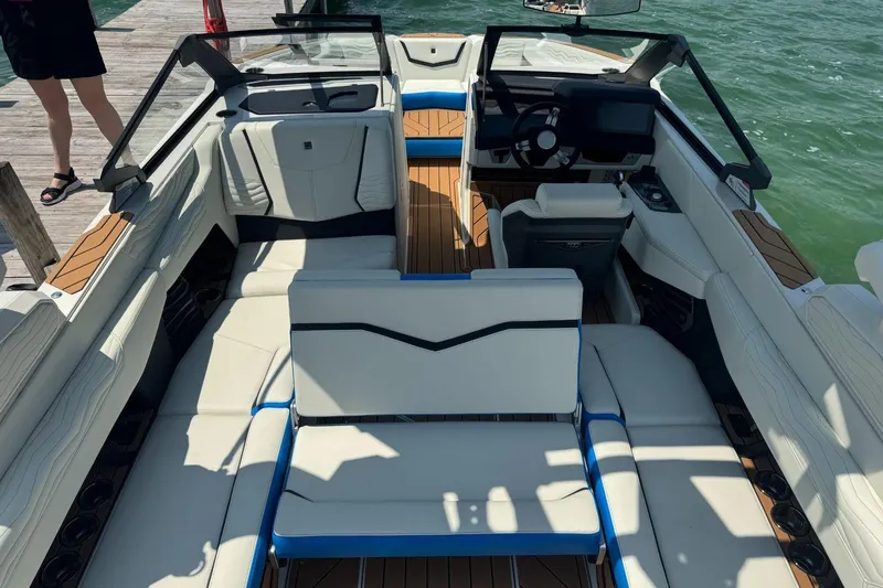 Slide: The Image of 2025 Nautique Super Air Nautique G23 boat interior with luxurious seating and modern dashboard. - 7