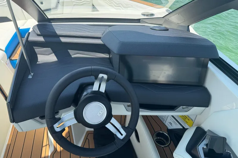Slide: The Image of 2025 Nautique Super Air Nautique G23 helm with sleek steering wheel and modern dashboard. - 9