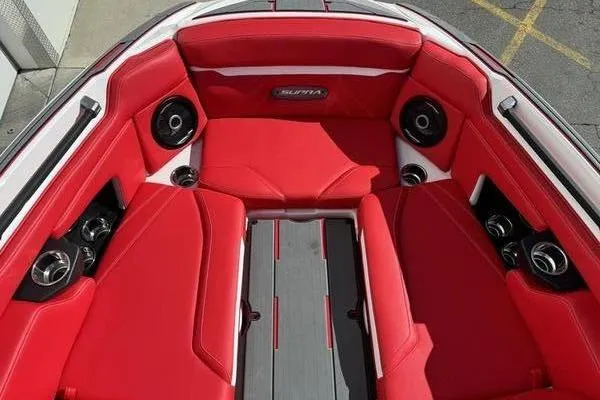 Slide: The Image of 2024 Supra SL 575 boat interior with red seating and built-in speakers. - 5