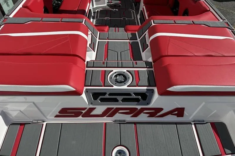 Slide: The Image of 2024 Supra SL 575 boat interior with red and gray seating and flooring. - 6