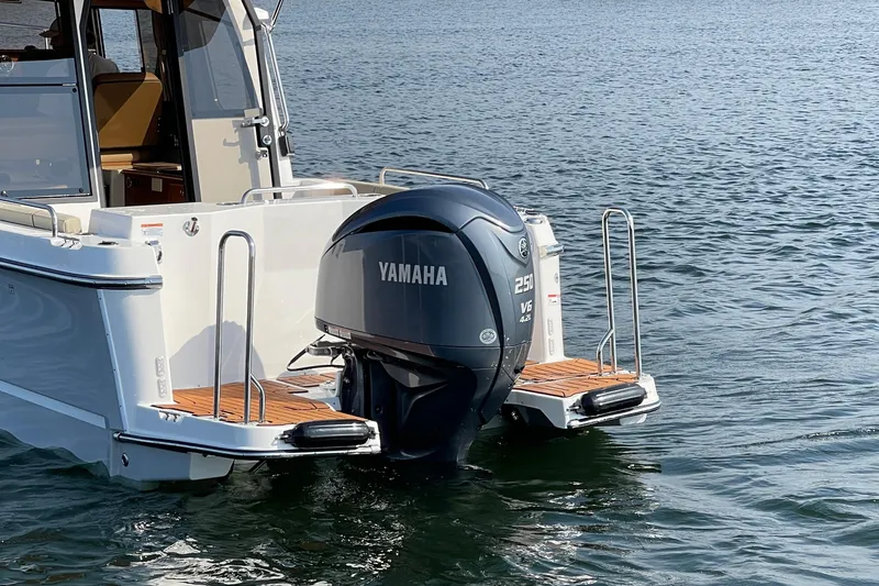 Slide: The Image of 2023 Ranger Tugs R-25 with Yamaha 250 V6 outboard motor on water. - 11