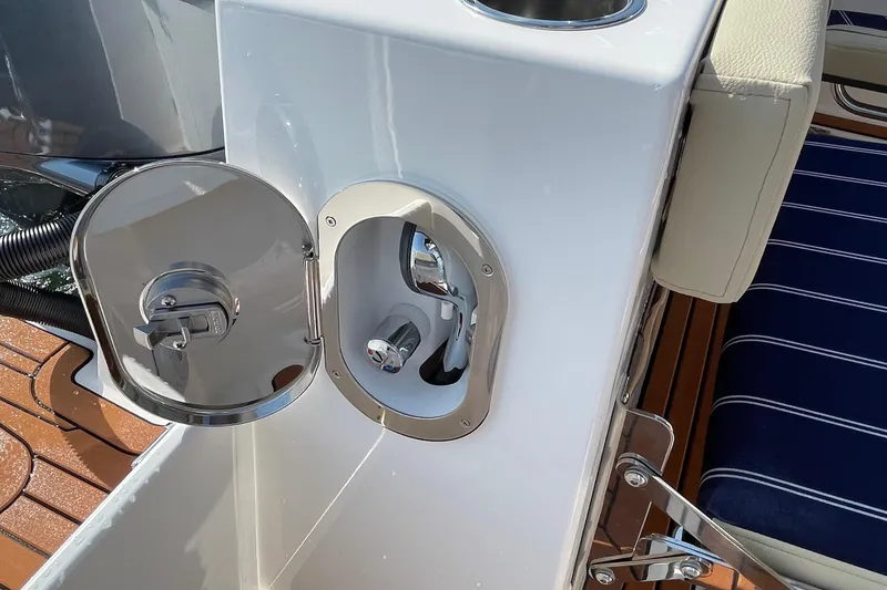Slide: The Image of 2023 Ranger Tugs R-25 boat detail showing a stainless steel fuel cap and seating area. - 25
