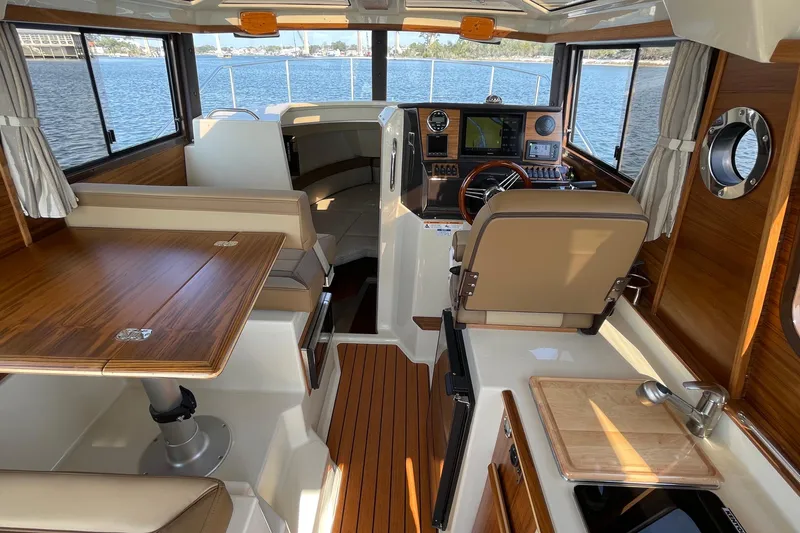 Slide: The Image of Interior of 2023 Ranger Tugs R-25 boat with wood finishes and modern navigation equipment. - 27