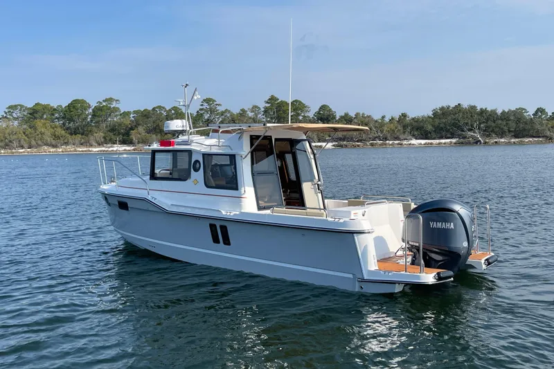 Slide: The Image of 2023 Ranger Tugs R-25 boat on calm water with Yamaha outboard motor. - 3