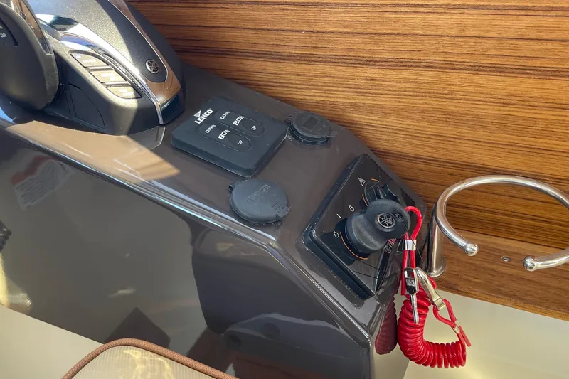 Slide: The Image of Control panel of 2023 Ranger Tugs R-25 boat with Yamaha throttle and safety lanyard. - 31