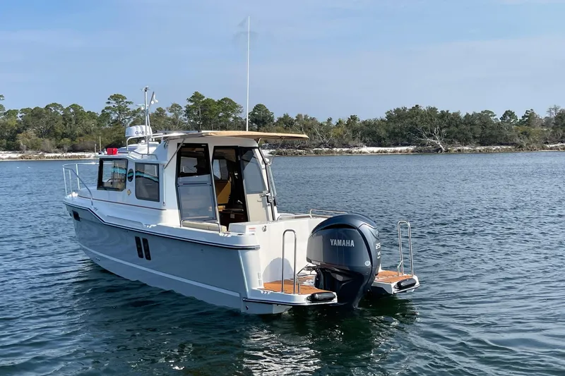 Slide: The Image of 2023 Ranger Tugs R-25 boat with Yamaha engine on calm water. - 4