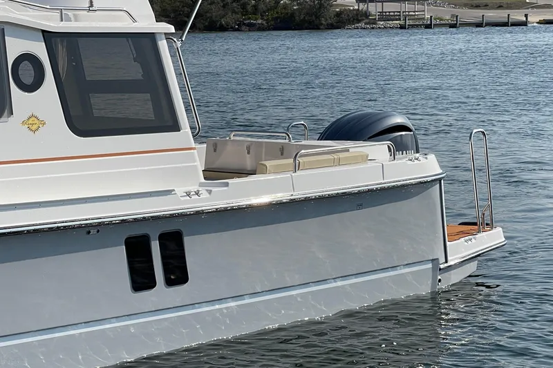 Slide: The Image of 2023 Ranger Tugs R-25 boat on water, showcasing sleek design and modern features. - 5