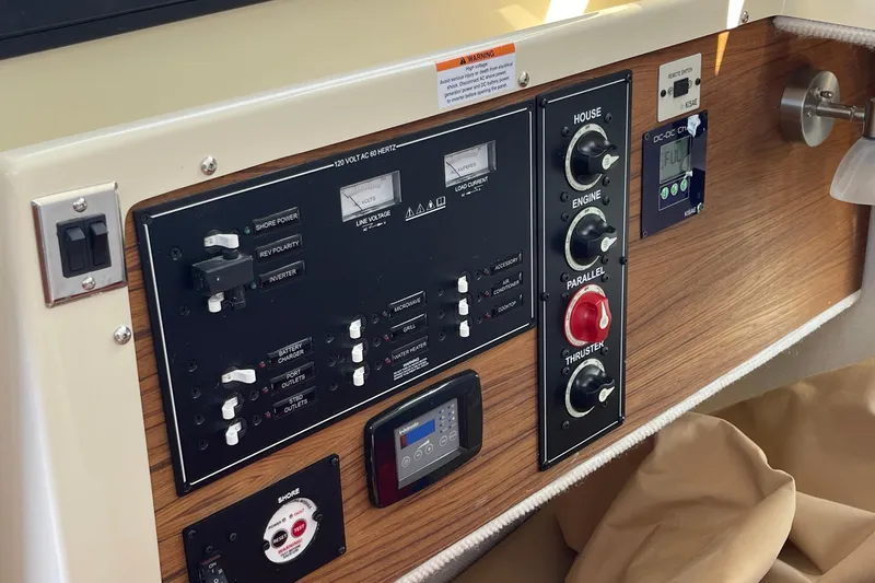 Slide: The Image of Control panel of 2023 Ranger Tugs R-25 boat with switches and gauges. - 53