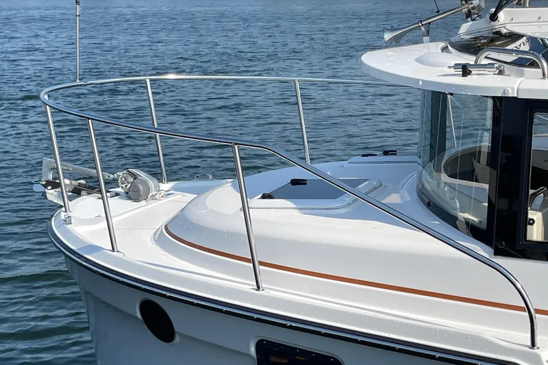 Slide: The Image of 2023 Ranger Tugs R-25 boat on water, featuring sleek design and modern amenities. - 7