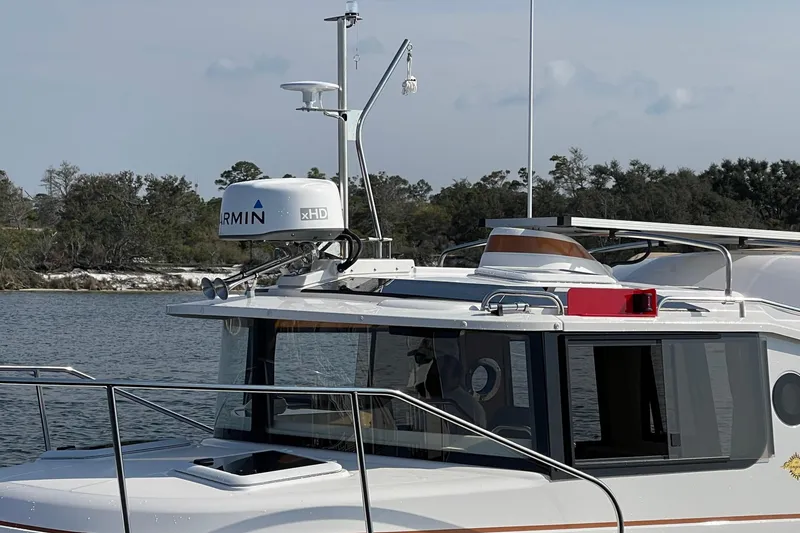 Slide: The Image of 2023 Ranger Tugs R-25 boat with Garmin xHD radar on calm water. - 8