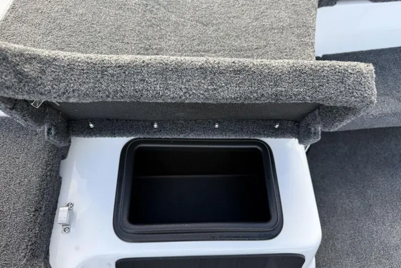Slide: The Image of Carpeted storage compartment in 2026 Skeeter ZXR19 SE boat interior. - 11