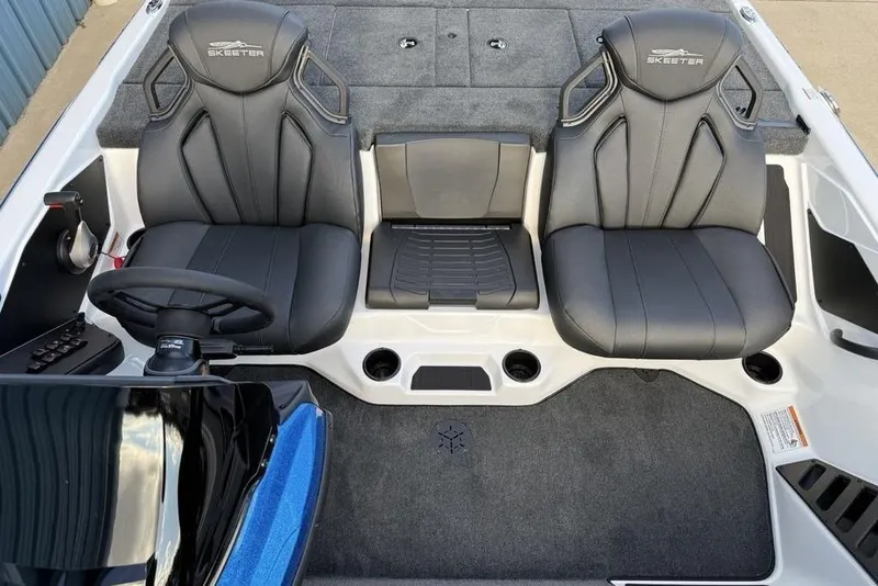 Slide: The Image of 2026 Skeeter ZXR19 SE boat interior with black seats and steering wheel. - 12