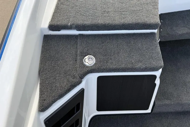 Slide: The Image of 2026 Skeeter ZXR19 SE boat interior with carpeted steps and storage compartment. - 16