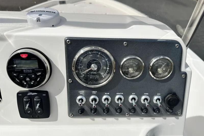 Slide: The Image of Control panel of a 2020 Blue Wave 2000 Classic boat with gauges and switches. - 15